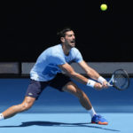 
              Serbia's Novak Djokovic plays a backhand return to during a practice session ahead of the Australian Open tennis championship in Melbourne, Australia, Friday, Jan. 13, 2023. (AP Photo/Mark Baker)
            