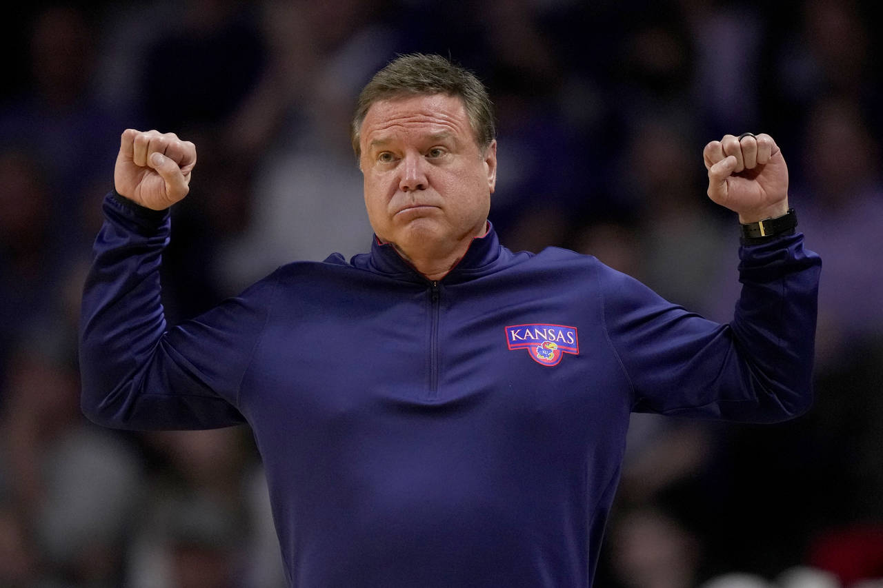 Kansas head coach Bill Self motions to his players during the second half of an NCAA college basket...