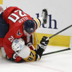 
              Washington Capitals center Lars Eller (20) takes down Pittsburgh Penguins center Sidney Crosby (87) during overtime of an NHL hockey game, Thursday, Jan. 26, 2023, in Washington. The Capitals won 3-2 in a shootout. (AP Photo/Nick Wass)
            