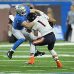 
              Detroit Lions defensive end Aidan Hutchinson tackles Chicago Bears quarterback Justin Fields (1) during the first half of an NFL football game, Sunday, Jan. 1, 2023, in Detroit. (AP Photo/Paul Sancya)
            
