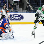 
              Dallas Stars' Jason Robertson (21) shoots the puck past New York Islanders goaltender Ilya Sorokin (30) for a goal during the first period of an NHL hockey game Tuesday, Jan. 10, 2023, in Elmont, N.Y. (AP Photo/Frank Franklin II)
            