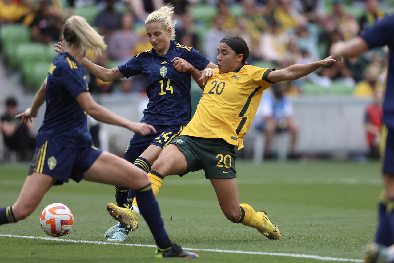 FILE - Australia's Sam Kerr (20) scores against Sweden's Nathalie Bjorn (14) during their women's f...
