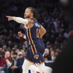 
              New York Knicks guard Jalen Brunson (11) gestures during the first half of an NBA basketball game against the Phoenix Suns, Monday, Jan. 2, 2023, in New York. (AP Photo/Jessie Alcheh)
            