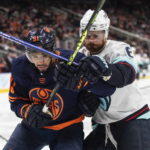 
              Seattle Kraken's Adam Larsson (6) and Edmonton Oilers' Evander Kane (91) compete for the puck during the second period of an NHL hockey game Tuesday, Jan. 17, 2023, in Edmonton, Alberta. (Jason Franson/The Canadian Press via AP)
            