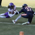 
              Minnesota Vikings wide receiver Justin Jefferson (18) catches a pass in front of Chicago Bears safety Elijah Hicks (37) during the first half of an NFL football game, Sunday, Jan. 8, 2023, in Chicago. (AP Photo/Charles Rex Arbogast)
            