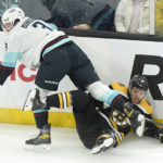 
              Seattle Kraken defenseman Will Borgen (3) and Boston Bruins left wing Taylor Hall, right, crash into the boards after colliding during the first period of an NHL hockey game Thursday, Jan. 12, 2023, in Boston. (AP Photo/Steven Senne)
            