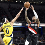
              Portland Trail Blazers guard Damian Lillard, right, shoots over Indiana Pacers guard Tyrese Haliburton, left, during the second half of an NBA basketball game, Friday, Jan. 6, 2023, in Indianapolis. (AP Photo/Marc Lebryk)
            