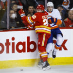 
              New York Islanders defenseman Noah Dobson, right, is checked by Calgary Flames forward Blake Coleman during the second period of an NHL hockey game Friday, Jan. 6, 2023, in Calgary, Alberta. (Jeff McIntosh/The Canadian Press via AP)
            