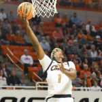 
              Oklahoma State guard Bryce Thompson (1) drives to the basket during the first half of an NCAA college basketball game against Texas, Saturday, Jan. 7, 2023, in Stillwater, Okla. Texas defeated Oklahoma State 56-46. (AP Photo/Brody Schmidt)
            