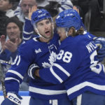 
              Toronto Maple Leafs right wing William Nylander (88) celebrates after his goal against the New York Islanders with teammate John Tavares (91) during second-period NHL hockey game action in Toronto, Ontario, Monday, Jan. 23, 2023. (Nathan Denette/The Canadian Press via AP)
            