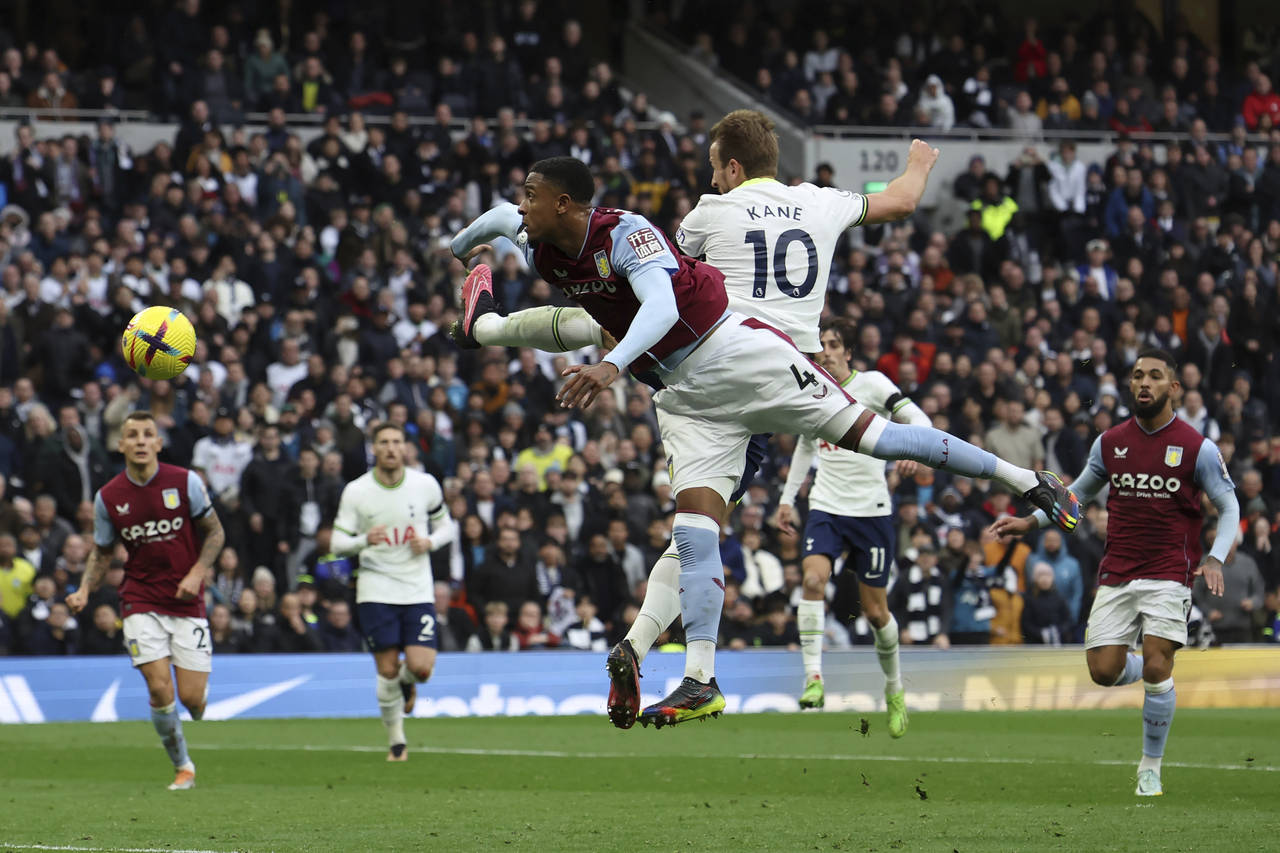 Tottenham's Harry Kane (10) heads past Aston Villa's Ezri Konsa in an attempt to score during the E...