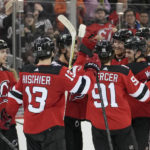 
              New Jersey Devils defenseman Dougie Hamilton, third from right, celebrates with his teammates after scoring the winning goal in overtime of an NHL hockey game, Tuesday, Jan. 24, 2023, in Newark, N.J. The Devils won 3-2. (AP Photo/Mary Altaffer)
            