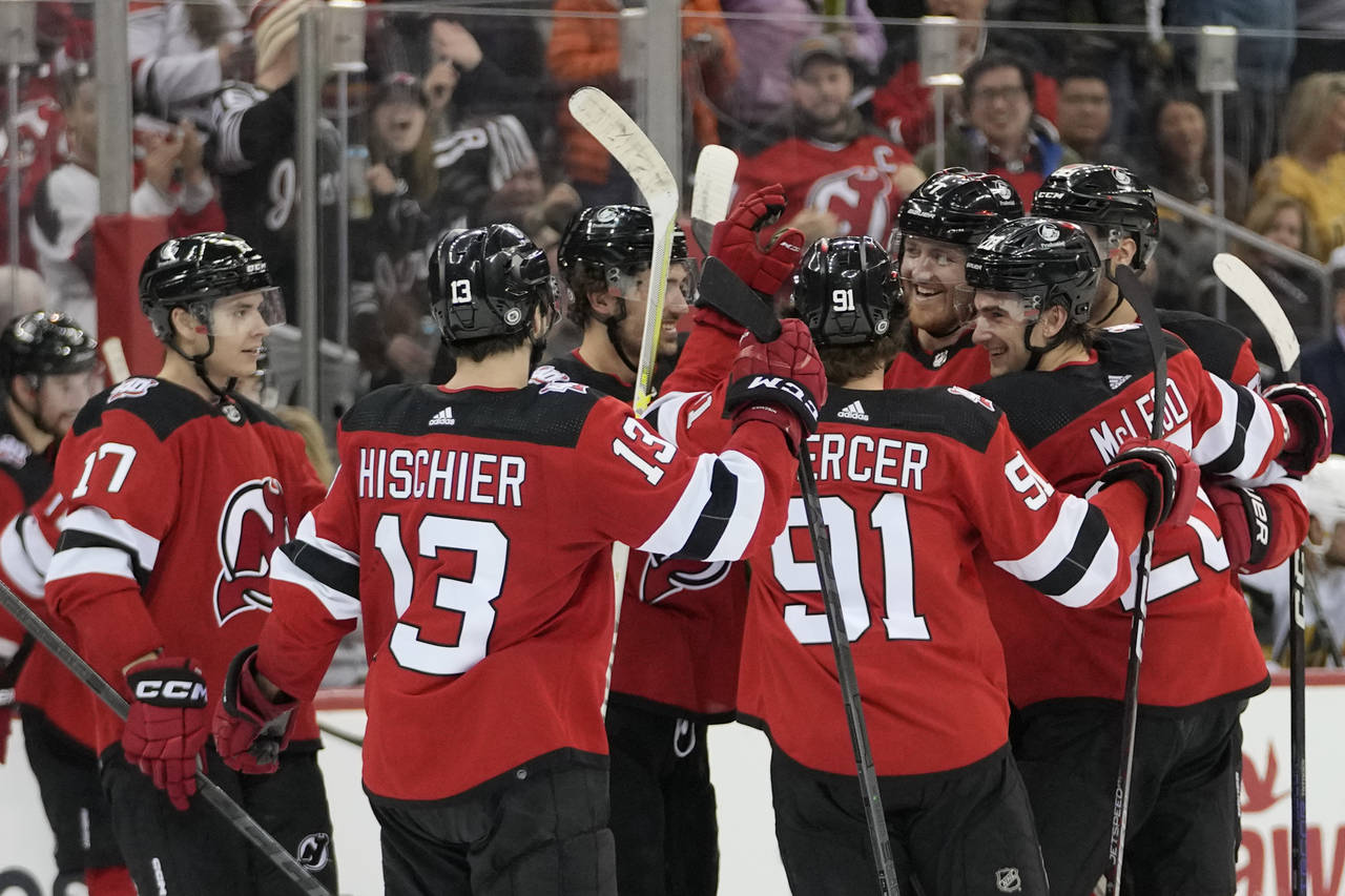 New Jersey Devils defenseman Dougie Hamilton, third from right, celebrates with his teammates after...