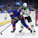 
              New York Islanders' Scott Mayfield (24) fights for control of the puck with Dallas Stars' Tyler Seguin (91) during the first period of an NHL hockey game Tuesday, Jan. 10, 2023, in Elmont, N.Y. (AP Photo/Frank Franklin II)
            