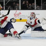 
              Florida Panthers defenseman Marc Staal (18) and Florida Panthers goaltender Sergei Bobrovsky (72) dive for a puck against the Vegas Golden Knights during the second period of an NHL hockey game Thursday, Jan. 12, 2023, in Las Vegas. (AP Photo/John Locher)
            