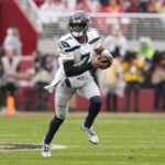 
              Seattle Seahawks quarterback Geno Smith (7) scrambles against the San Francisco 49ers during the first half of an NFL wild card playoff football game in Santa Clara, Calif., Saturday, Jan. 14, 2023. (AP Photo/Godofredo A. Vásquez)
            