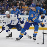 
              St. Louis Blues' Colton Parayko (55) controls the puck as Tampa Bay Lightning's Anthony Cirelli (71) defends during the third period of an NHL hockey game Saturday, Jan. 14, 2023, in St. Louis. (AP Photo/Jeff Roberson)
            
