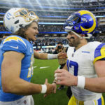
              Los Angeles Chargers quarterback Justin Herbert (10) and Los Angeles Rams quarterback Baker Mayfield (17) shake hands after an NFL football game Sunday, Jan. 1, 2023, in Inglewood, Calif. The Chargers won 31-10. (AP Photo/Marcio Jose Sanchez)
            