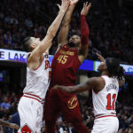 
              Cleveland Cavaliers guard Donovan Mitchell (45) shoots against Chicago Bulls center Nikola Vucevic (9) and guard Ayo Dosunmu (12) during the second half of an NBA basketball game, Monday, Jan. 2, 2023, in Cleveland. (AP Photo/Ron Schwane)
            