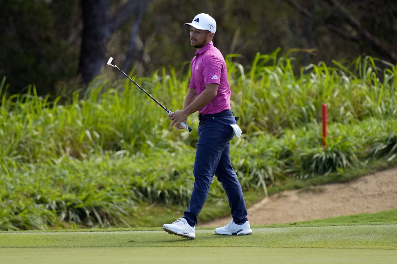 Xander Schauffele reacts after his shot on the 14th green during the second round of the Tournament...
