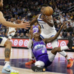 
              Utah Jazz forward Jarred Vanderbilt (8) reaches for the ball with Minnesota Timberwolves guard Anthony Edwards (1) and forward Kyle Anderson (5) defending in the first quarter of an NBA basketball game Monday, Jan. 16, 2023, in Minneapolis. (AP Photo/Andy Clayton-King)
            