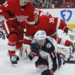 
              Columbus Blue Jackets left wing Johnny Gaudreau (13) falls to the ice after getting hit in the face with a stick with Detroit Red Wings left wing Dominik Kubalik (81) protecting his goalie during the second period of an NHL hockey game Saturday, Jan. 14, 2023, in Detroit. (AP Photo/Duane Burleson)
            