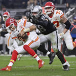 
              Kansas City Chiefs quarterback Patrick Mahomes (15) is sacked by Las Vegas Raiders defensive end Maxx Crosby (98) as Chiefs guard Andrew Wylie (77) watches during the second half of an NFL football game Saturday, Jan. 7, 2023, in Las Vegas. (AP Photo/David Becker)
            