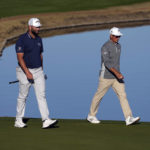 
              Jon Rahm, left, walks to the ninth green with Rickie Fowler during the American Express golf tournament on the Nicklaus Tournament Course at PGA West Friday, Jan. 20, 2023, in La Quinta, Calif. (AP Photo/Mark J. Terrill)
            