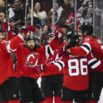 
              New Jersey Devils' Jack Hughes (86) celebrates with teammates after scoring a goal during the first period of an NHL hockey game against the Pittsburgh Penguins, Sunday, Jan. 22, 2023, in Newark, N.J. (AP Photo/Frank Franklin II)
            