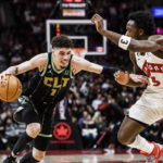 
              Charlotte Hornets guard LaMelo Ball (1) advances past Toronto Raptors forward O.G. Anunoby (3) during the second half of an NBA basketball game in Toronto on Tuesday, Jan. 10, 2023. (Christopher Katsarov/The Canadian Press via AP)
            