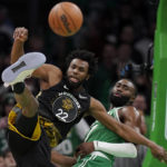 
              Golden State Warriors forward Andrew Wiggins (22) and Boston Celtics guard Jaylen Brown (7) vie for control of the ball in the second half of an NBA basketball game, Thursday, Jan. 19, 2023, in Boston. (AP Photo/Steven Senne)
            