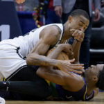 
              Brooklyn Nets center Nic Claxton, top, battles New Orleans Pelicans forward Herbert Jones, bottom, for the ball in the first half of an NBA basketball game in New Orleans, Friday, Jan. 6, 2023. (AP Photo/Matthew Hinton)
            