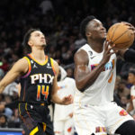 
              Miami Heat guard Victor Oladipo (4) drives to the basket as Phoenix Suns guard Landry Shamet (14) arrives late during the first half of an NBA basketball game in Phoenix, Friday, Jan. 6, 2023. (AP Photo/Ross D. Franklin)
            