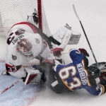 
              St. Louis Blues' Jake Neighbours (63) collides with Ottawa Senators goaltender Cam Talbot (33) during the third period of an NHL hockey game Monday, Jan. 16, 2023, in St. Louis. (AP Photo/Jeff Roberson)
            