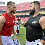 
              FILE - Kansas City Chiefs tight end Travis Kelce, left, talks to his brother, Philadelphia Eagles center Jason Kelce, after they exchanged jerseys following an NFL football game in Kansas City, Mo., Sept. 17, 2017. For the first time in Super Bowl history, a pair of siblings will play each other on the NFL's grandest stage. Travis helped the Chiefs return to their third championship game in four seasons on Sunday night when they beat the Bengals for the AFC title, while Jason has the Eagles back for the second time in six years after their NFC title win over the 49ers. (AP Photo/Ed Zurga, file)
            
