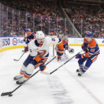 
              New York Islanders' Hudson Fasching (20) is chased by Edmonton Oilers' Ryan Nugent-Hopkins (93) during third-period NHL hockey game action in Edmonton, Alberta, Thursday, Jan. 5, 2023. (Jason Franson/The Canadian Press via AP)
            