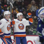 
              New York Islanders' Ross Johnston, left, and Aatu Raty celebrate Raty's goal against Vancouver Canucks goalie Spencer Martin during the second period of an NHL hockey game Tuesday, Jan. 3, 2023, in Vancouver, British Columbia. (Darryl Dyck/The Canadian Press via AP)
            