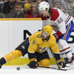 
              Nashville Predators left wing Filip Forsberg (9) and Montreal Canadiens left wing Michael Pezzetta (55) battle for the puck during the first period of an NHL hockey game Tuesday, Jan. 3, 2023, in Nashville, Tenn. (AP Photo/Mark Zaleski)
            