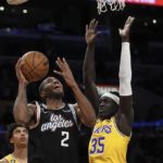 
              Los Angeles Clippers forward Kawhi Leonard, left, shoots as Los Angeles Lakers forward Wenyen Gabriel defends during the first half of an NBA basketball game Tuesday, Jan. 24, 2023, in Los Angeles. (AP Photo/Mark J. Terrill)
            