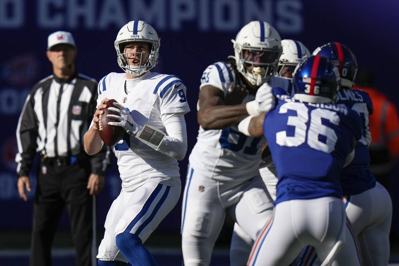 Indianapolis Colts' Nick Foles (9) looks to pass during the first half of an NFL football game agai...