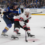 
              Ottawa Senators' Dylan Gambrell (27) handles the puck as St. Louis Blues' Tyler Tucker (75) defends during the first period of an NHL hockey game Monday, Jan. 16, 2023, in St. Louis. (AP Photo/Jeff Roberson)
            