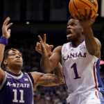 
              Kansas guard Joseph Yesufu (1) puts up a shot under pressure from Kansas State forward Keyontae Johnson (11) during the first half of an NCAA college basketball game Tuesday, Jan. 31, 2023, in Lawrence, Kan. (AP Photo/Charlie Riedel)
            