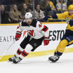 
              New Jersey Devils left wing Miles Wood (44) moves the puck ahead of Nashville Predators defenseman Jeremy Lauzon (3) during the first period of an NHL hockey game Thursday, Jan. 26, 2023, in Nashville, Tenn. (AP Photo/Mark Zaleski)
            