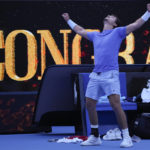 
              J.J. Wolf of the U.S. celebrates after defeating compatriot Michael Mmoh in their third round match at the Australian Open tennis championship in Melbourne, Australia, Saturday, Jan. 21, 2023. (AP Photo/Dita Alangkara)
            