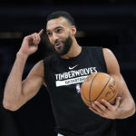 
              Minnesota Timberwolves center Rudy Gobert gestures while warming up for the team's NBA basketball game against the Phoenix Suns, Friday, Jan. 13, 2023, in Minneapolis. (AP Photo/Abbie Parr)
            