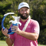 
              Jon Rahm, of Spain, holds the champions trophy after the final round of the Tournament of Champions golf event, Sunday, Jan. 8, 2023, at Kapalua Plantation Course in Kapalua, Hawaii. (AP Photo/Matt York)
            