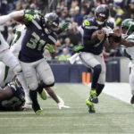 
              Seattle Seahawks quarterback Geno Smith runs for a first down as New York Jets cornerback D.J. Reed (4) defends during the first half of an NFL football game, Sunday, Jan. 1, 2023, in Seattle. (AP Photo/Ted S. Warren)
            