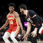 
              Atlanta Hawks forward De'Andre Hunter, left, looks to get past Portland Trail Blazers center Jusuf Nurkic, right, during the first half of an NBA basketball game in Portland, Ore., Monday, Jan. 30, 2023. (AP Photo/Steve Dykes)
            