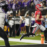 
              Georgia quarterback Stetson Bennett (13) runs into the end zone for a touchdown against TCU during the first half of the national championship NCAA College Football Playoff game, Monday, Jan. 9, 2023, in Inglewood, Calif. (AP Photo/Marcio Jose Sanchez)
            