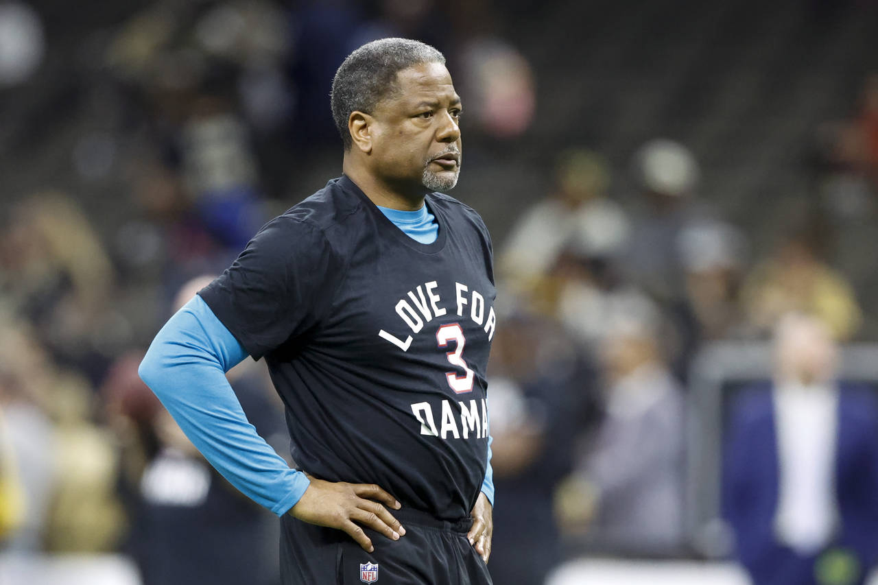 FILE - Carolina Panthers' Steve Wilks warms up wearing a T-shirt in support of Buffalo Bills player...